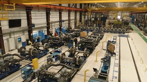 A drone in a subway chassis assembly shop. Workers in masks tighten nuts doing Stock Footage 195119220