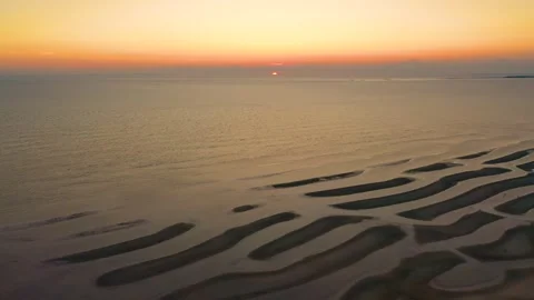 Drone Sunrise Over Cape Cod Tidal Flats and Golden Ocean Reflection 動画素材 325781365