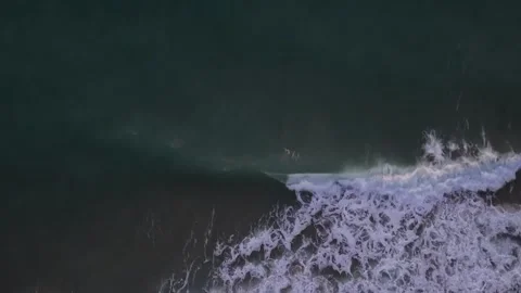 Drone sunrise view of ocean waves breaking along peaceful shoreline Stock Footage 321899197