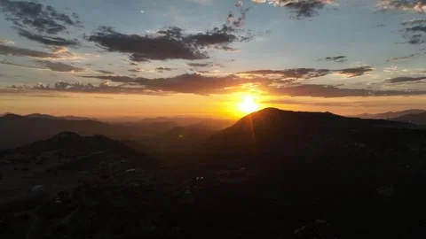 Drone sunset behind mountain over rural Ca area 動画素材 252083022