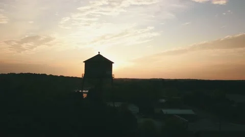 Drone at Sunset Circles a Water Tower in 4K Video stock 234454676