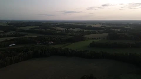 Drone sunset flight over rural landscape with fields and forest Stock Footage 317024286