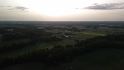 Drone sunset flight over rural landscape with fields and forest Stock Footage 317024365