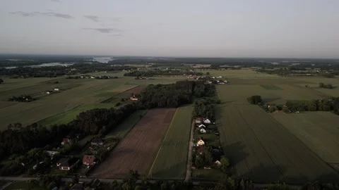 Drone sunset flight over rural landscape with fields and forest Stock Footage 317024433