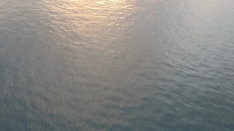 Drone, sunset over calm ocean, reveal islands silhouette Stock Footage 130316084