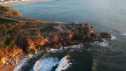 Drone sunset over Nazaré Lighthouse and Atlantic waves in Portugal. Stock Footage 329118712