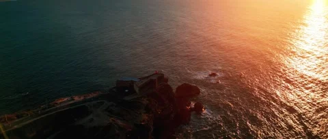 Drone sunset over Nazaré Lighthouse and Atlantic waves in Portugal. Stock Footage 329118841