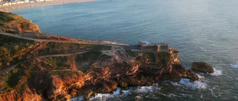 Drone sunset over Nazaré Lighthouse and Atlantic waves in Portugal. Stock Footage 329118848