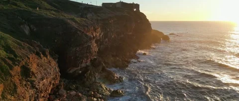 Drone sunset over Nazaré Lighthouse and Atlantic waves in Portugal. Stock Footage 329118860