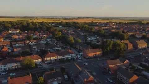 Drone, sunset. Rooftops. UK Housing development. Suburban housing property. Stock Footage 257070074