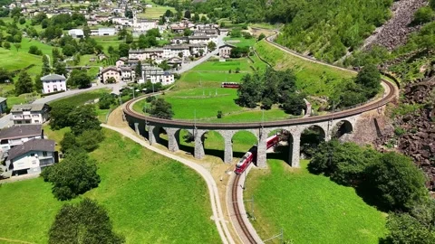 Drone Switzerland 4k. train to St. Moritz. Brusio spiral viaduct, Swiss Alps Stock Footage 345682744
