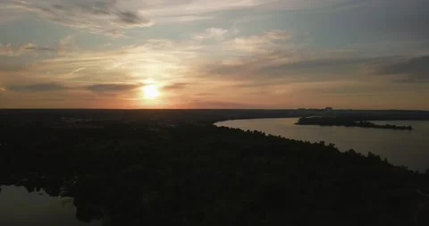 Drone take off during a beautiful sunset overlooking the forest and the river Stock-Footage 136021733