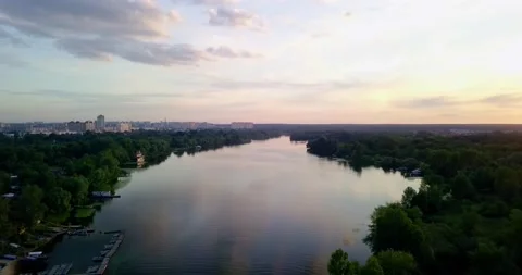 Drone take off during a beautiful sunset overlooking the forest and the river Stock Footage 136068799