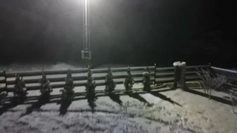 Drone take off to the light dark. Drone is moving to the lamp over the fence Stock Footage 197363870