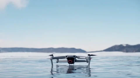 Drone takeoff. the quadcopter takes off from the smooth ice of Lake Baikal. Stock Footage 173738451