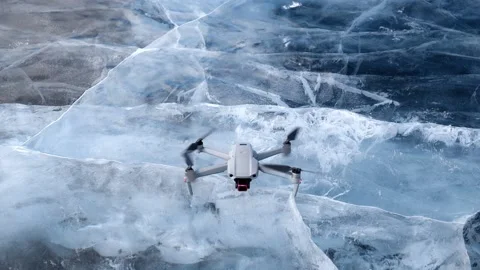 Drone takeoff. the quadcopter takes off from the smooth ice of Lake Baikal. Video stock 173738454