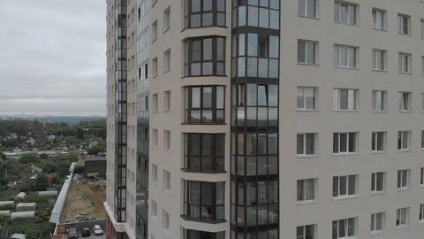 A drone takes a close-up of a window of an apartment building moving Stock Footage 118888433