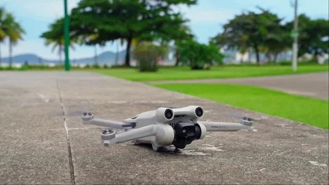 Drone takes off to fly in the sky against the background of the garden. Stock Footage 243799902