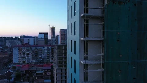The drone takes off next to a multi-storey building under construction Stock Footage 152082984
