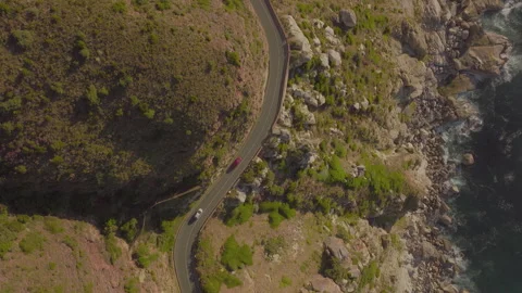 Drone takes off over cliffside, ocean bay and mountains in scenic landscape Stock Footage 288094177