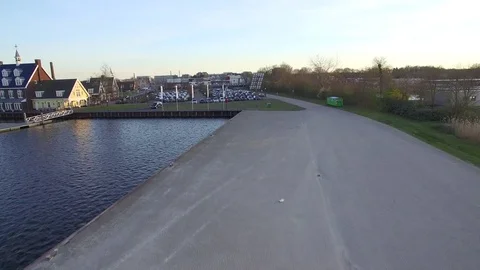 Drone taking of and flying over parking lot in a harbor Stock Footage 75351659