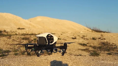Drone taking off from ground over the hills Stock Footage 89884616