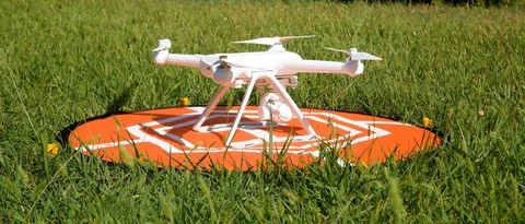 Drone taking off from a landing pad leaning on a lawn Stock Footage 94225400