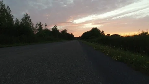 Drone taking off over rural road during beautiful pink sunset - 24fps 1080p Stock Footage 104104353