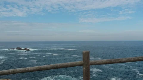 Drone taking off over the sea from behind a fence Stock Footage 123216270