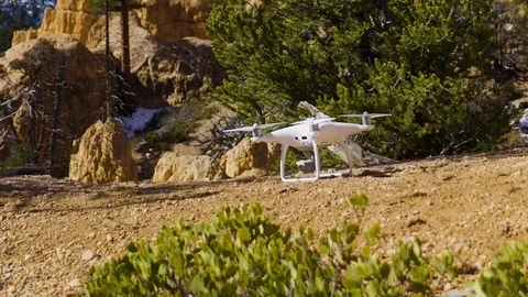 Drone taking off with red rocks and snow in background near Bryce Canyon Stock Footage 98855484
