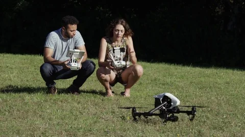 Drone Taking Off In Super Slow Motion With Man and Woman Hip Tech Engineers Stock Footage 82592490