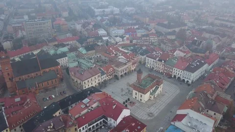 Drone of Tarnow, Poland's Main Square and Church During Foggy/Hazey Morning Stock Footage 90217497