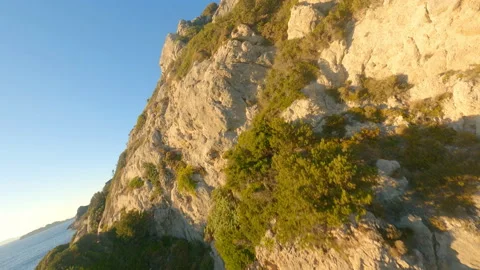 Drone Through Rock Arch And Over Coastal Cliffs Video stock 166867271