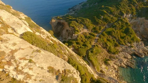 Drone Through Rock Arch And Corfu Coastline Stock Footage 166867292