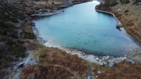 Drone Tilt Up From Blue Water Surface To Shore. Kazakhstan, Sayram-Ugam Park Stock Footage 332787269