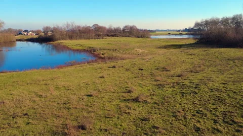 Drone tilt up dune lake with ascending birds Stock Footage 305480276