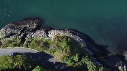 Drone tilt shot of forest panning to sea and hills, Oban, 4K UHD Stock Footage 169732695