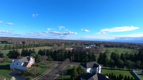 Drone tilt shot over fields and suburban homes Stock Footage 127721241