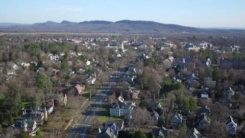 A Drone Tilts Down Over A Northampton Neighborhood, Pans Left. Stock Footage 329773766
