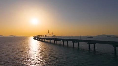 Drone Tilts Up Over Incheon Bridge Toward Setting Sun South Korea Stock Footage 345366988