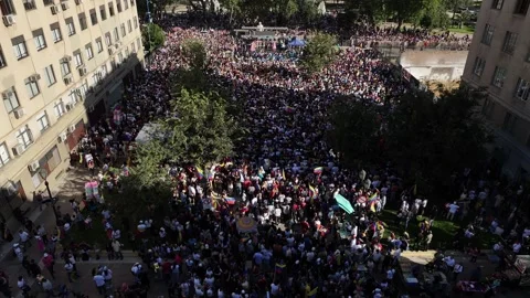 Drone tilts from overhead crowd to stage at Paseo Bulnes Santiago Chile Stock Footage 332532684