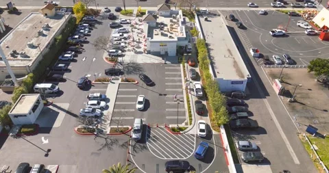 Drone time lapse captures lunch rush at In-N-Out fast food restaurant in Stock Footage 233139997