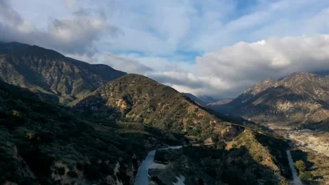 Drone Time Lapse of Clouds Moving over a Mountain Road and Terrain Stock Footage 150722281