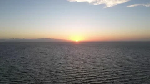 Drone Time-Lapse of the Setting Sun over Calm Sea Waves Stock Footage 319962831