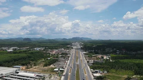Drone timelapse - clouds moving fast over the road Stock Footage 192571396