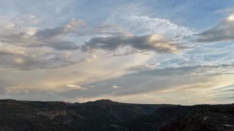 Drone Timelapse of Color Shifting Dusk Clouds Over a Southwest Canyon Valley Video stock 337200638