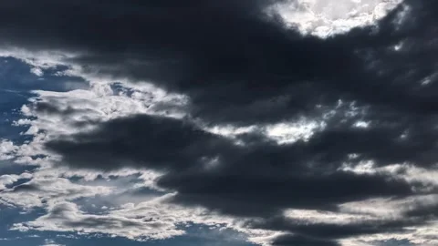 Drone Timelapse of Dark Grey Clouds Dispersing as Sun Rays Break Through Stock Footage 337200472