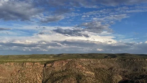 Drone Timelapse of Evolving Clouds Over a Sweeping Desert Canyon Edge Stock Footage 336526841
