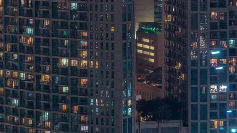 Drone timelapse Glowing apartment windows night Dubai skyscraper shot Stock Footage 337945822