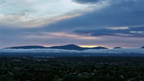 Drone Timelapse of Opposing Cloud and Fog Layers Over Mountains with Sky Tilt Stock Footage 336956156